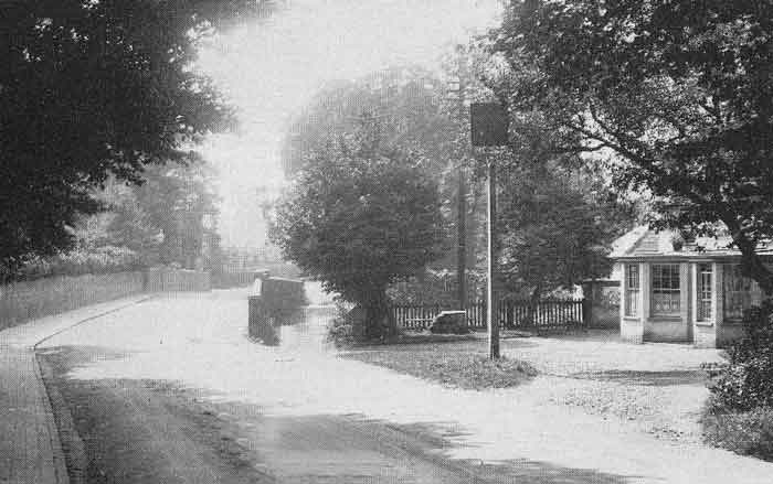 road with inn sign, building largely hidden